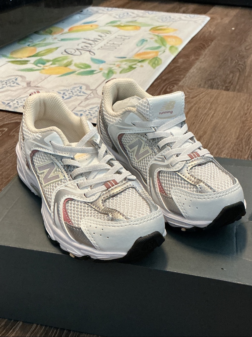 New Balance Kids White and Pink Accented Sneakers